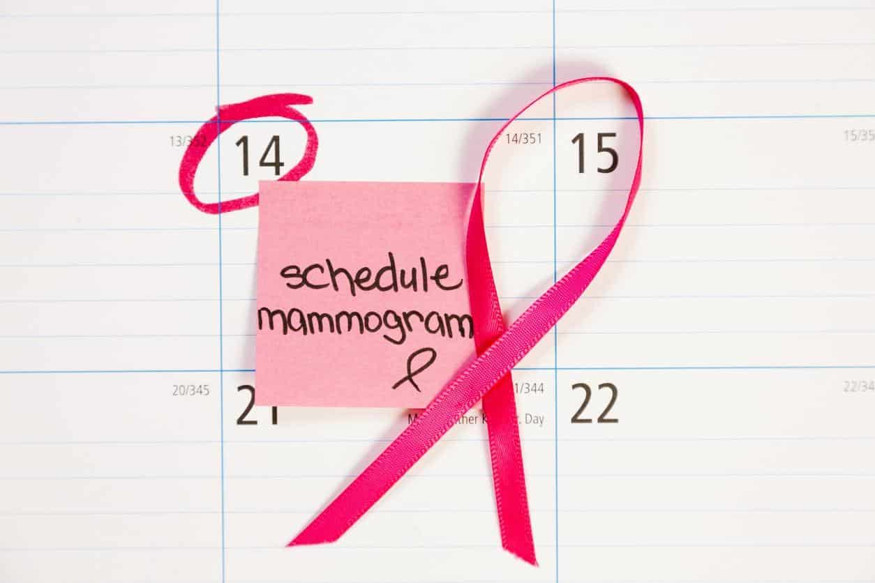 Mammogram appointment reminder note circled on calendar. Pink ribbon.