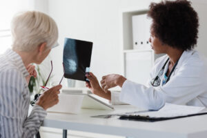Female doctor looking at test results of her patient. Breast examination. Mammogram.
