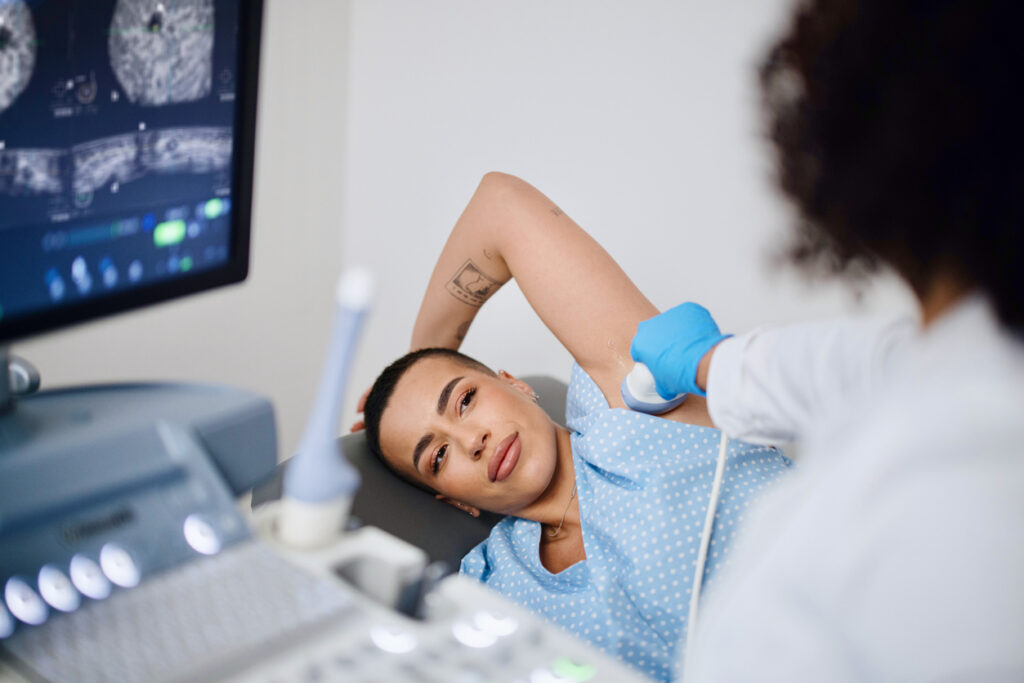 A young woman is doing a breast ultrasound for preventive breast cancer care